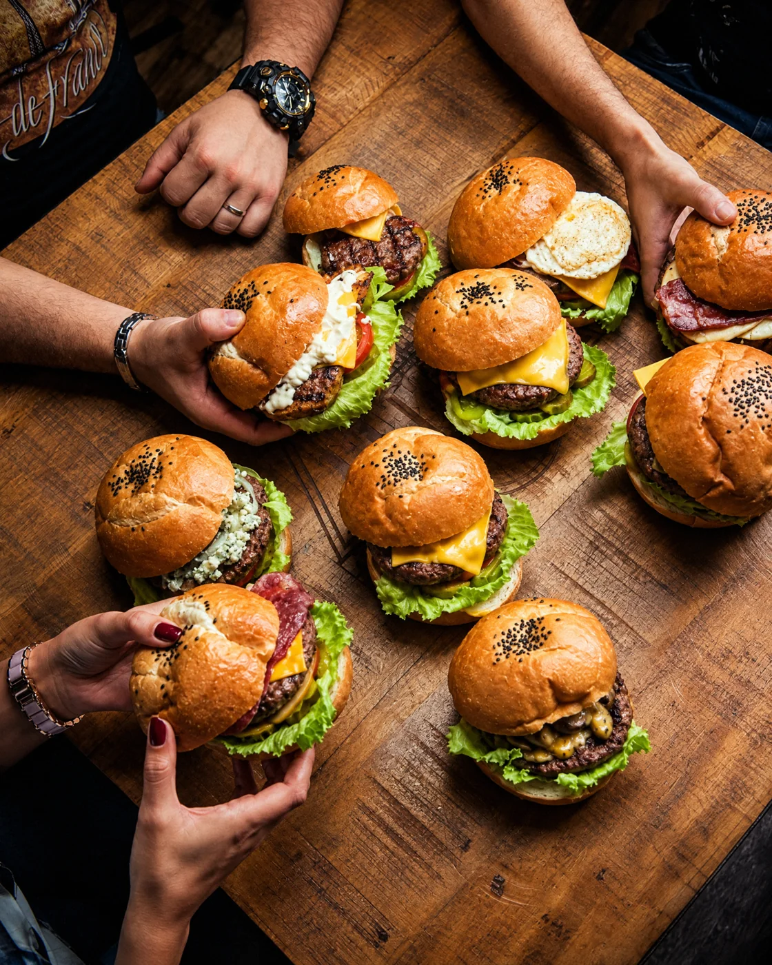 A table full of Firefly burgers shared by a group of friends