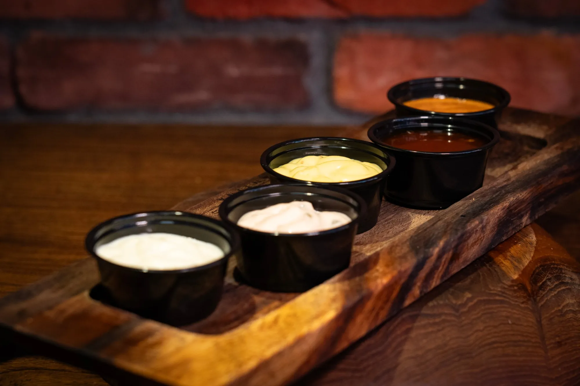 Firefly house sauces in a wooden tray